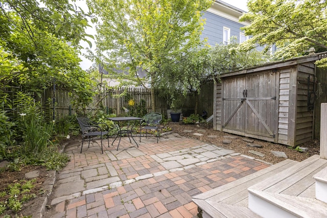 80 Melbourne St, Portland, ME 04101 - fenced backyard with a patio, a storage shed, and outdoor dining space