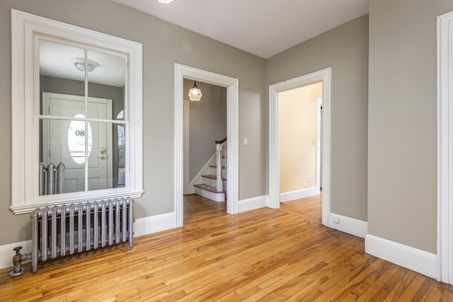 80 Melbourne St, Portland, ME 04101 - empty room featuring radiator, wood-type flooring, and stairs