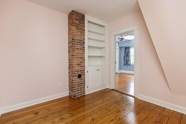 80 Melbourne St, Portland, ME 04101 - unfurnished living room with hardwood / wood-style flooring and built in shelves