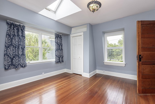 80 Melbourne St, Portland, ME 04101 - unfurnished bedroom with a skylight, dark wood finished floors, and a closet
