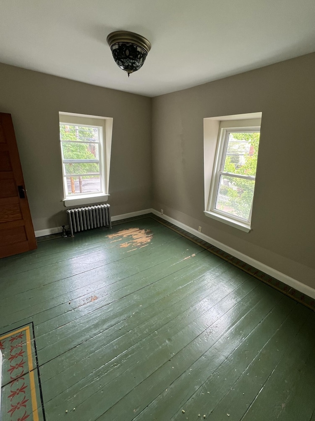 80 Melbourne St, Portland, ME 04101 - unfurnished room with radiator heating unit, healthy amount of natural light, and hardwood / wood-style flooring