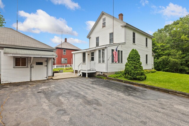 33 Maple St, Limerick, ME 04048 - view of home's exterior with a chimney, a yard, and an outbuilding