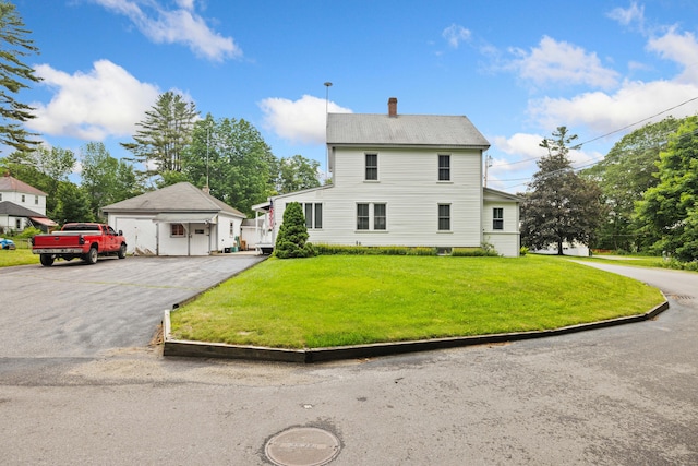 33 Maple St, Limerick, ME 04048 - view of front of house featuring a front lawn, a chimney, and an outdoor structure