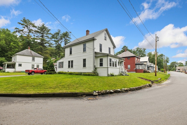 33 Maple St, Limerick, ME 04048 - view of property exterior featuring a chimney, entry steps, and a yard