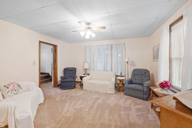 33 Maple St, Limerick, ME 04048 - living area with carpet flooring, a ceiling fan, stairway, and a drop ceiling