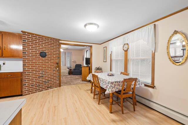 33 Maple St, Limerick, ME 04048 - dining room featuring a baseboard heating unit, ornamental molding, and light wood finished floors