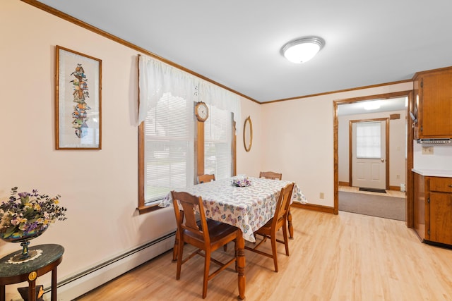 33 Maple St, Limerick, ME 04048 - dining room with a baseboard heating unit, light wood-style flooring, and ornamental molding