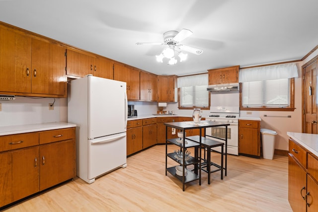 33 Maple St, Limerick, ME 04048 - kitchen featuring white appliances, under cabinet range hood, brown cabinets, ceiling fan, and light wood finished floors