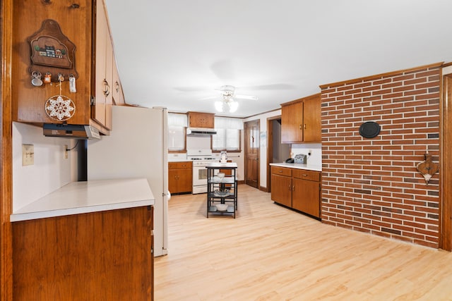 33 Maple St, Limerick, ME 04048 - kitchen with white appliances, light countertops, light wood-type flooring, brown cabinetry, and ceiling fan