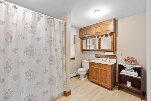 33 Maple St, Limerick, ME 04048 - bathroom featuring baseboard heating, wood finished floors, vanity, and a shower with curtain