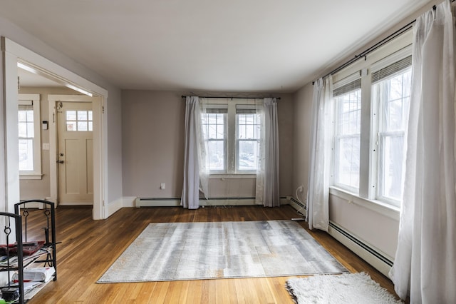 272 Center St, Bangor, ME 04401 - foyer featuring wood finished floors, a baseboard heating unit, and baseboard heating