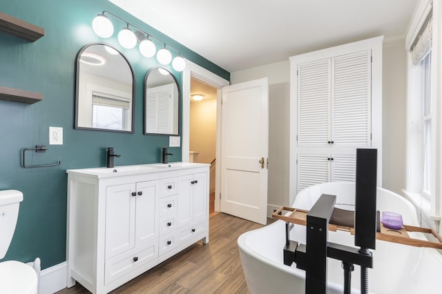 272 Center St, Bangor, ME 04401 - full bath with wood finished floors, double vanity, a closet, and a soaking tub