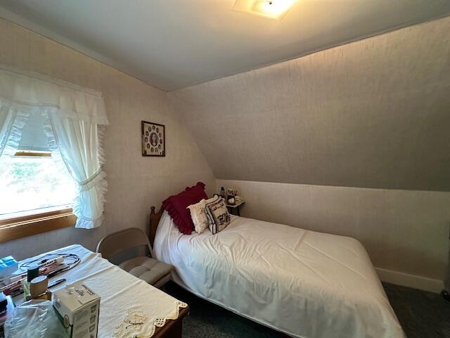 28 Charles St, Belfast, ME 04915 - bedroom with vaulted ceiling and dark carpet