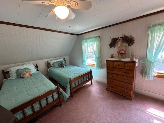 28 Charles St, Belfast, ME 04915 - bedroom with ornamental molding, vaulted ceiling, light colored carpet, wallpapered walls, and a ceiling fan