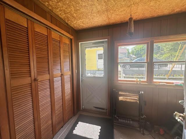 28 Charles St, Belfast, ME 04915 - doorway to outside featuring carpet floors and wood walls