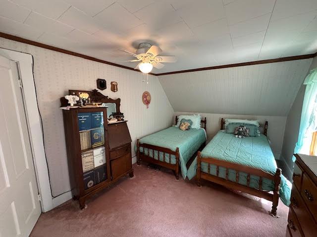 28 Charles St, Belfast, ME 04915 - carpeted bedroom featuring ornamental molding, vaulted ceiling, and a ceiling fan