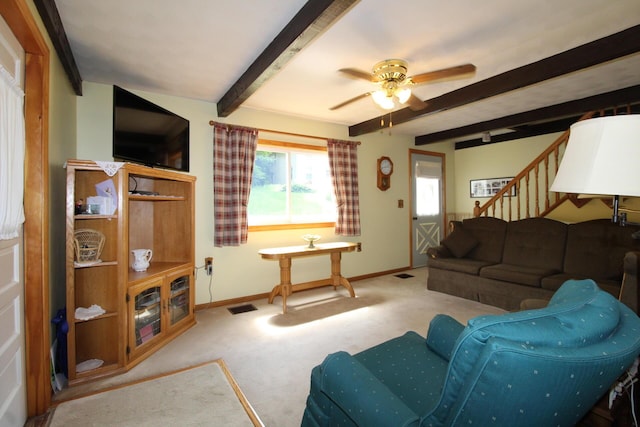 28 Charles St, Belfast, ME 04915 - living room featuring beamed ceiling, carpet flooring, stairs, and ceiling fan