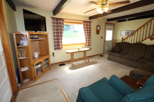 28 Charles St, Belfast, ME 04915 - living room featuring beamed ceiling, a ceiling fan, carpet floors, and stairs