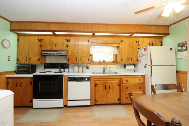 28 Charles St, Belfast, ME 04915 - kitchen with white appliances, under cabinet range hood, light countertops, light wood-style flooring, and brown cabinetry