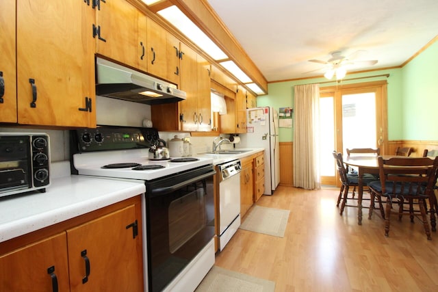 28 Charles St, Belfast, ME 04915 - kitchen featuring white appliances, under cabinet range hood, light countertops, ornamental molding, and light wood-style flooring