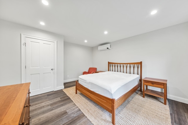 701 Wallston Rd, Saint George, ME 04860 - bedroom featuring an AC wall unit, dark wood finished floors, and recessed lighting