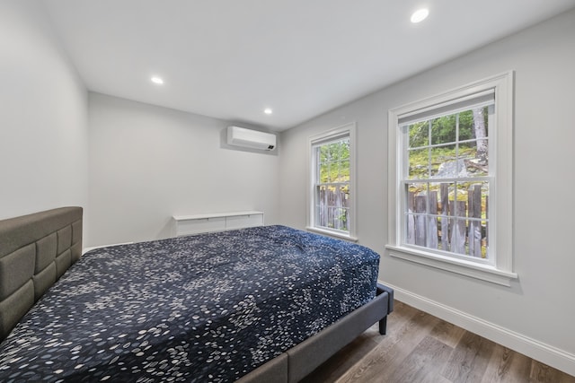 701 Wallston Rd, Saint George, ME 04860 - bedroom featuring a wall unit AC, wood finished floors, and recessed lighting