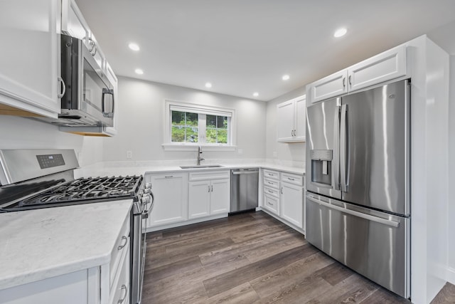 701 Wallston Rd, Saint George, ME 04860 - kitchen with appliances with stainless steel finishes, white cabinetry, dark wood-style floors, recessed lighting, and light stone counters