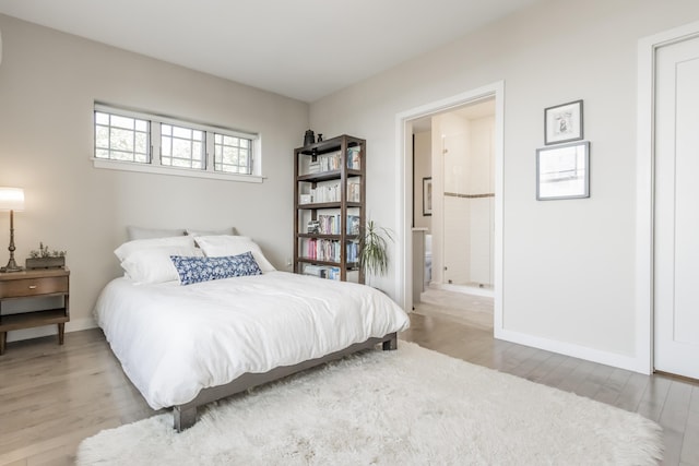 156 Sheridan St Unit 2A, Portland, ME 04101 - bedroom featuring light wood finished floors and ensuite bathroom