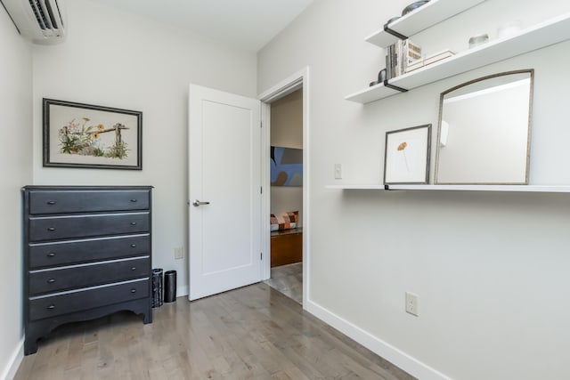 156 Sheridan St Unit 2A, Portland, ME 04101 - unfurnished bedroom with an AC wall unit and light wood-style flooring