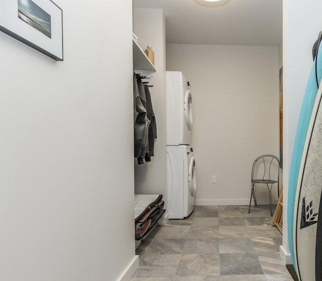 156 Sheridan St Unit 2A, Portland, ME 04101 - laundry area with stacked washer / dryer and baseboards