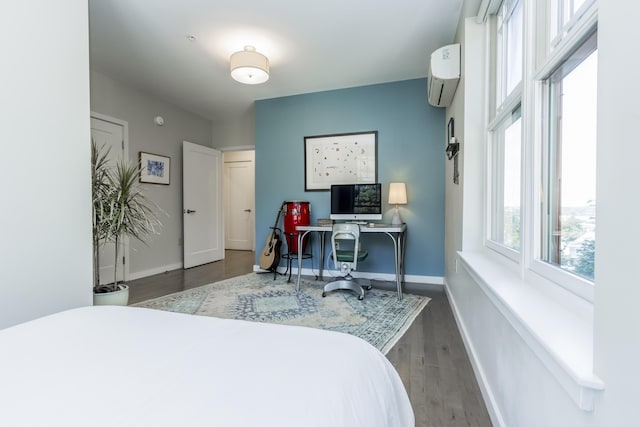 156 Sheridan St Unit 2A, Portland, ME 04101 - bedroom with a wall unit AC and wood finished floors