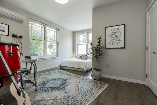 156 Sheridan St Unit 2A, Portland, ME 04101 - bedroom with a wall mounted AC, wood finished floors, and a desk