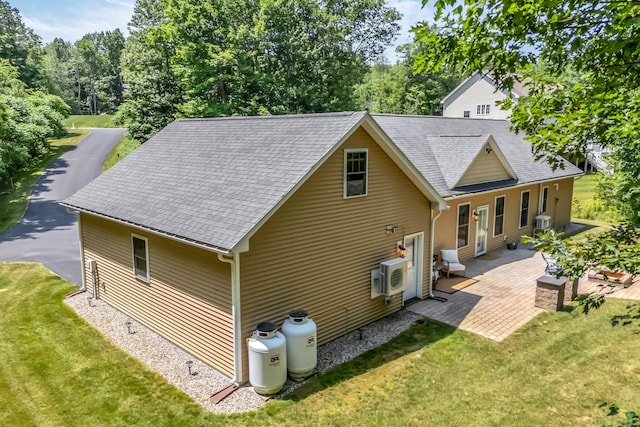 187 Hickory Dr, Auburn, ME 04210 - rear view of property with a lawn, a patio, and roof with shingles