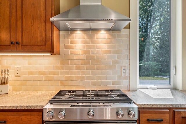 187 Hickory Dr, Auburn, ME 04210 - kitchen featuring wall chimney range hood, range, and brown cabinetry