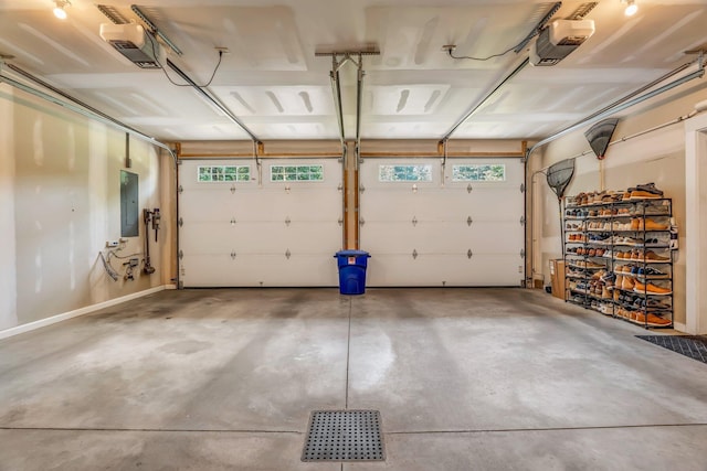 187 Hickory Dr, Auburn, ME 04210 - garage featuring a garage door opener and electric panel
