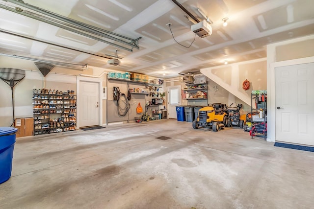 187 Hickory Dr, Auburn, ME 04210 - garage featuring a garage door opener and a workshop area