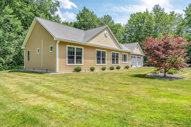 187 Hickory Dr, Auburn, ME 04210 - view of front facade featuring a garage, a front yard, and roof with shingles