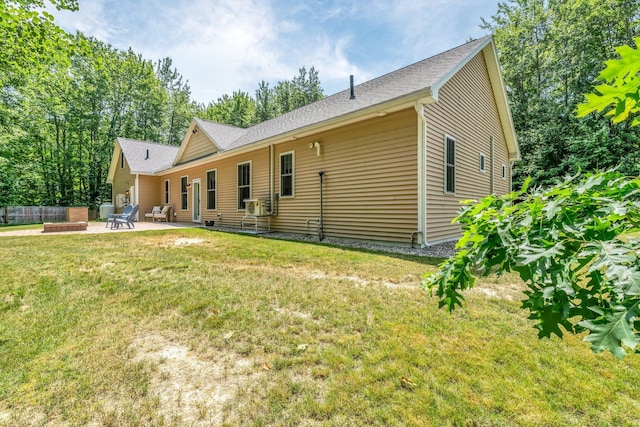 187 Hickory Dr, Auburn, ME 04210 - back of property with a patio area and roof with shingles