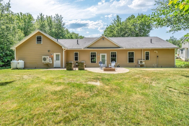 187 Hickory Dr, Auburn, ME 04210 - back of house featuring a patio area, a fire pit, a lawn, and roof with shingles