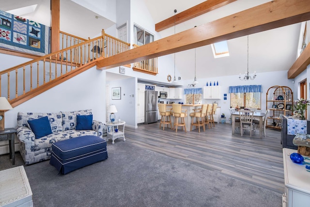 204 Nubble Rd, York, ME 03909 - living area featuring high vaulted ceiling, a chandelier, dark wood finished floors, stairway, and beam ceiling