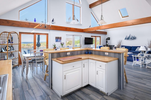 204 Nubble Rd, York, ME 03909 - kitchen with open floor plan, high vaulted ceiling, beam ceiling, a kitchen island, and white cabinetry