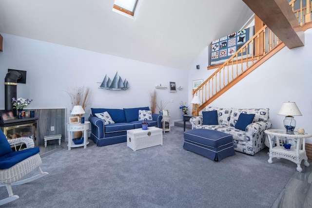 204 Nubble Rd, York, ME 03909 - carpeted living room with stairs, a skylight, high vaulted ceiling, and a wood stove