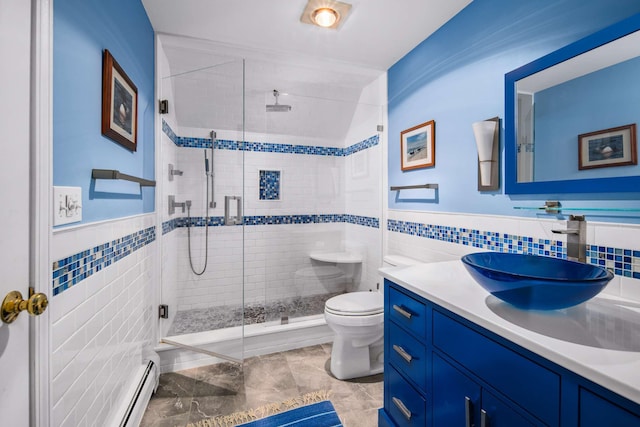204 Nubble Rd, York, ME 03909 - full bathroom with tile walls, vanity, a shower stall, baseboard heating, and wainscoting