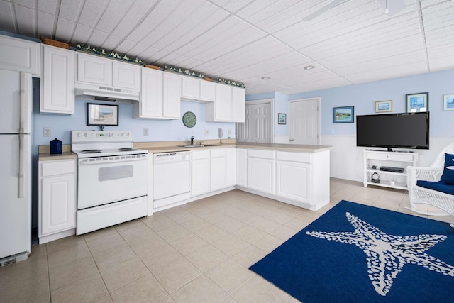 204 Nubble Rd, York, ME 03909 - kitchen featuring white appliances, under cabinet range hood, light countertops, light tile patterned floors, and white cabinets