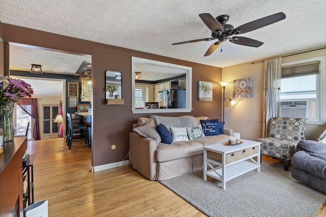 15 Lindale Ave, Biddeford, ME 04005 - living area with a textured ceiling, cooling unit, wood finished floors, and a ceiling fan