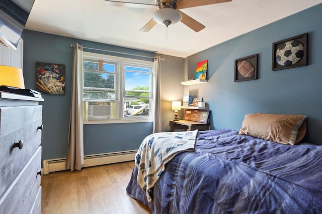 15 Lindale Ave, Biddeford, ME 04005 - bedroom with baseboard heating, wood finished floors, cooling unit, and ceiling fan