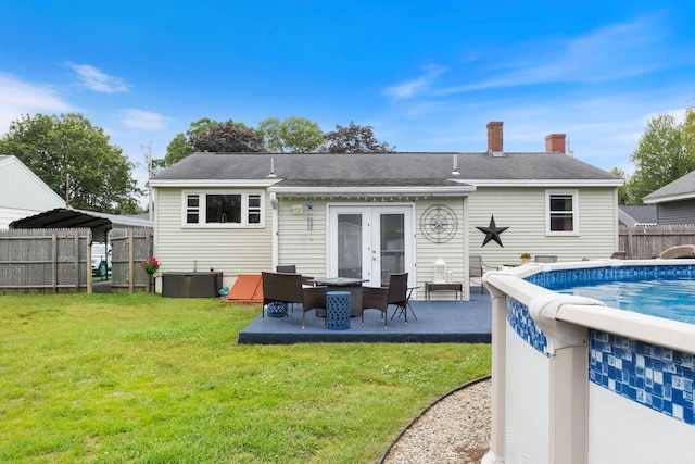 15 Lindale Ave, Biddeford, ME 04005 - rear view of property with french doors, a chimney, and a patio