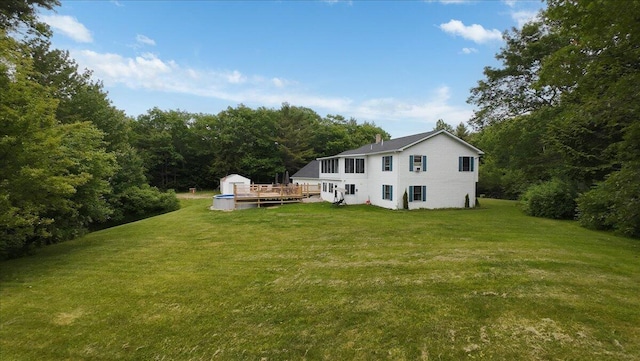 189 Old Chadbourne Rd, Lewiston, ME 04240 - view of green lawn featuring a storage shed, a wooden deck, and a view of trees