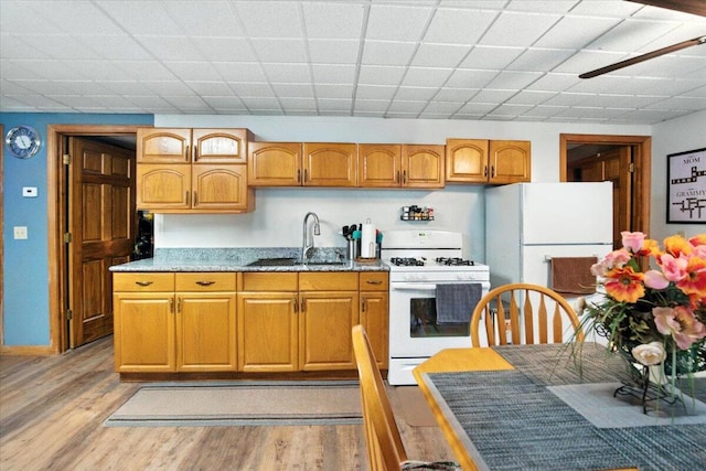 189 Old Chadbourne Rd, Lewiston, ME 04240 - kitchen featuring white appliances, light wood-style flooring, and brown cabinets