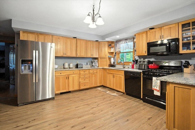 189 Old Chadbourne Rd, Lewiston, ME 04240 - kitchen featuring black appliances, a chandelier, open shelves, light wood-type flooring, and pendant lighting